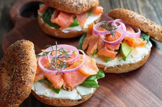 Bagel au saumon fumé, épinards, oignons rouges, avocat et fromage à la crème