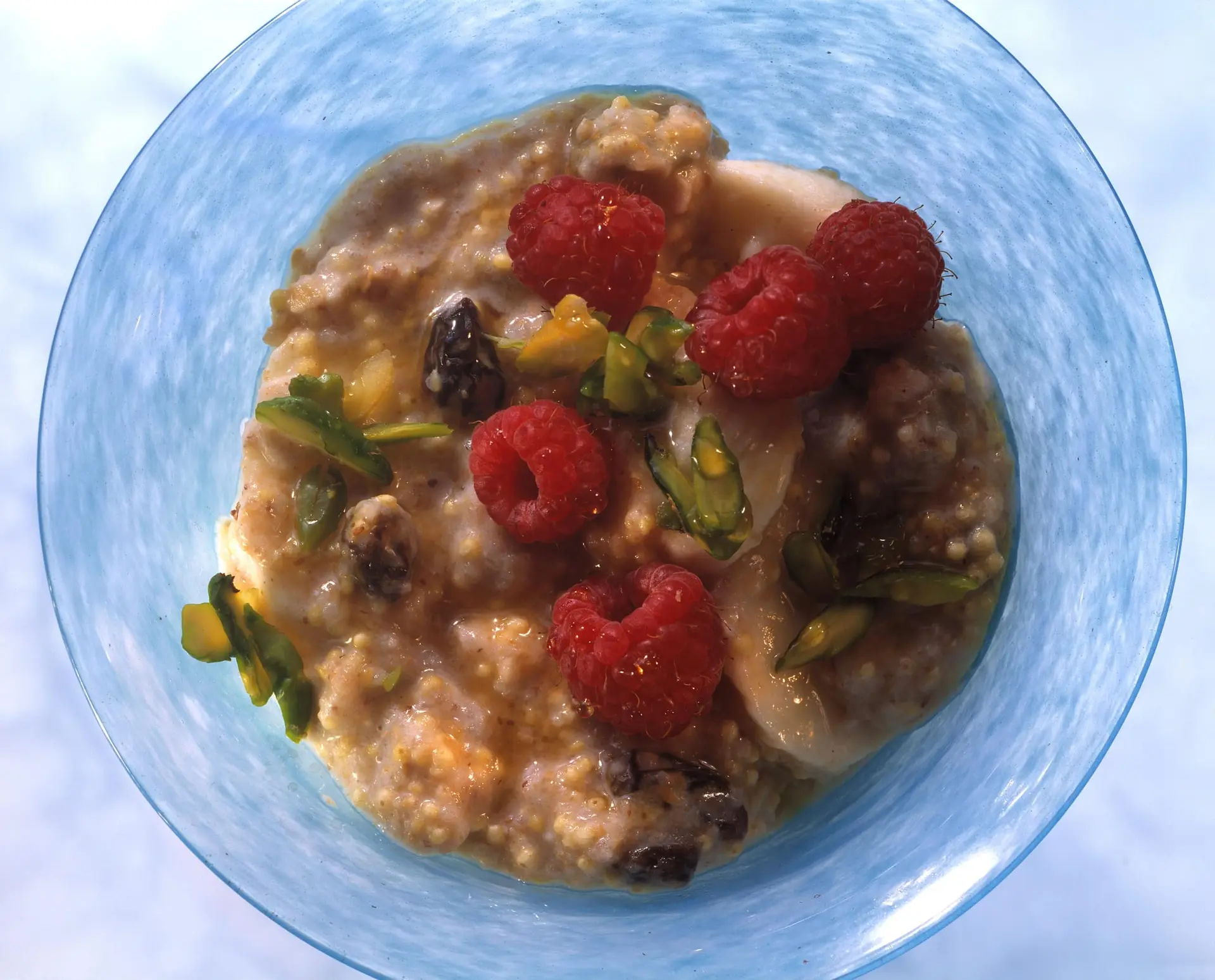 Porridge de céréales aux framboises, bananes et pistaches