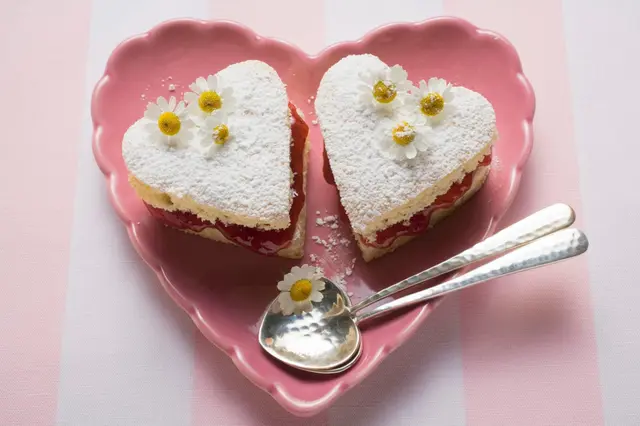 Gâteaux en forme de cœur avec confiture, sucre glace et marguerites